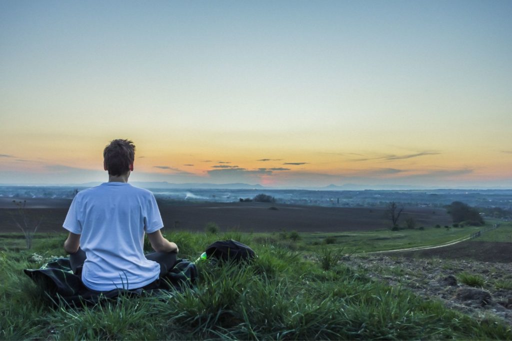 a person relaxing on a hill 