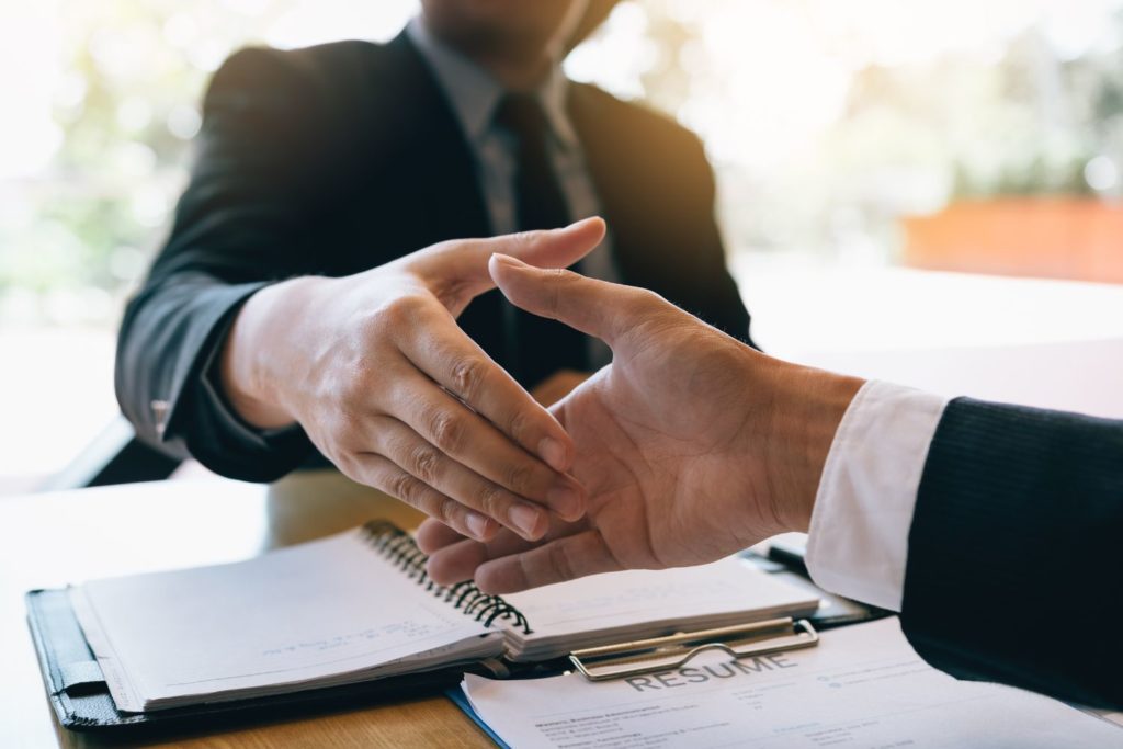 two people shaking hands after having a good conversation