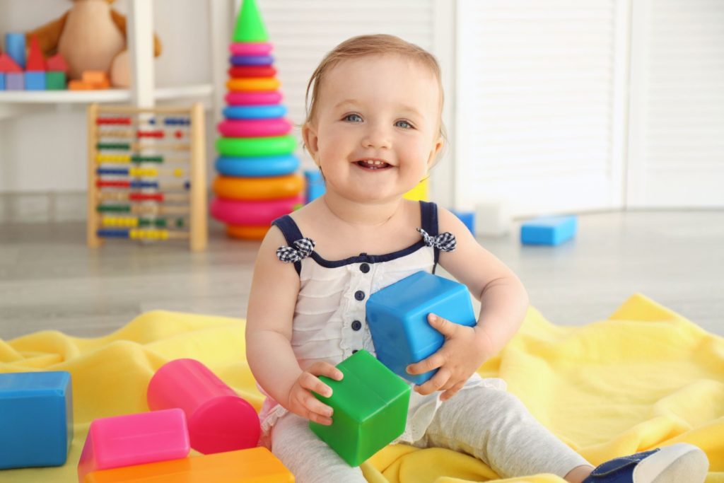 a young child playing with colorful blocks