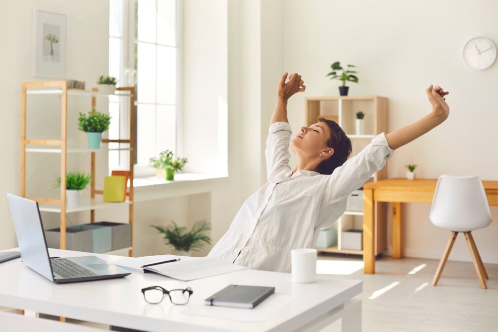 a mother stretching after a long day of working