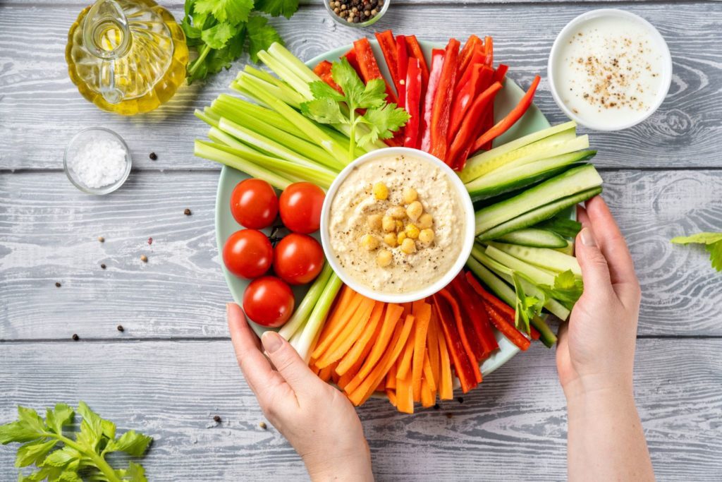 a vegetable tray with hummus